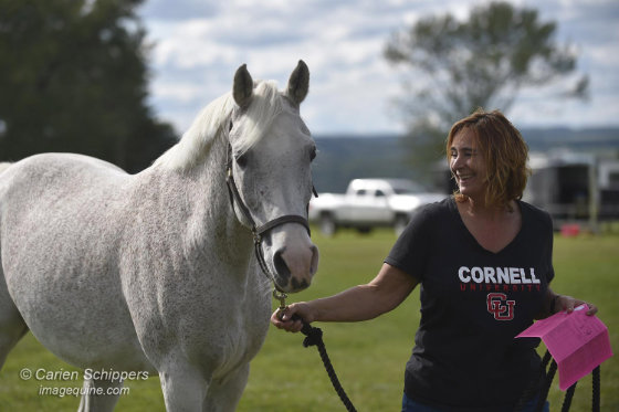 Patti walking with a white horse